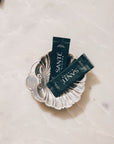 Two 'Sante' packets on a decorative silver dish with a light background
